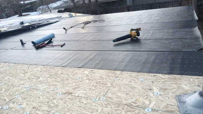 Roofing contractor inspecting and repairing hail-damaged residential roof – Chicago Hail Claims.